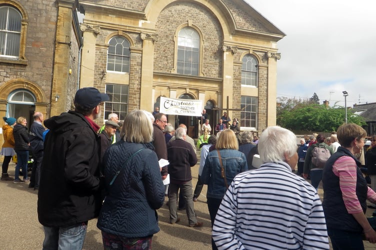 The cross is held at the top of the steps at Crediton Congregational Church where everyone joined in prayer and hymns.   SR 1557
