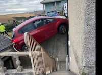 Rescue operation after car left hanging precariously over courtyard