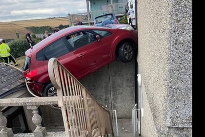 Rescue operation after car left hanging precariously over courtyard