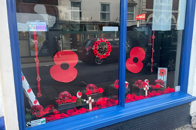 Knitted items form part of the remembrance display in Evans Newsagents window.  AQ 8186
