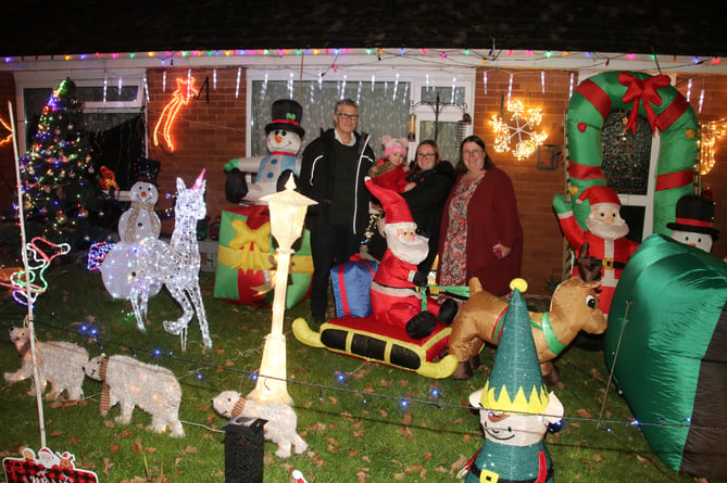 Alan Northcote, his wife Jill and their daughter Lucy with Tilly (2) with a part of the display of lights at 41 Meadowside Road, Sandford.  AQ 9414
