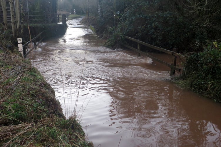 Swirling floodwater has reached a depth of about 15 inches across the road at Keymelford.  SR 3062
