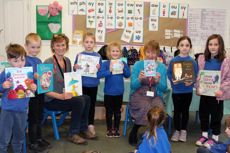 A few of the younger pupils at Yeoford School with Karen Rickey (left, seated) and Pauline Chater (centre, seated) from The Bookery.  SR 7028
