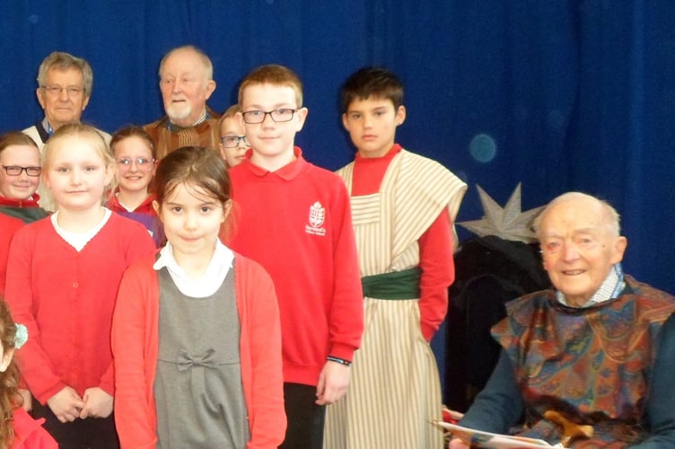 John, right, with Open the Book volunteers and some of the children at Hayward’s Primary School in Crediton.