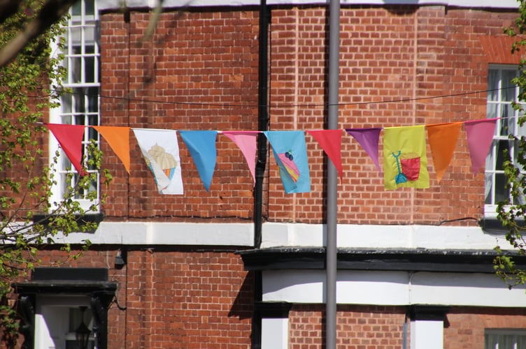 Flags in Crediton Town Square by Alan Quick