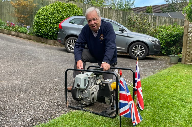 Lion Peter Bryan with the generator that the Lions Club of Crediton is donating.  AQ 7833