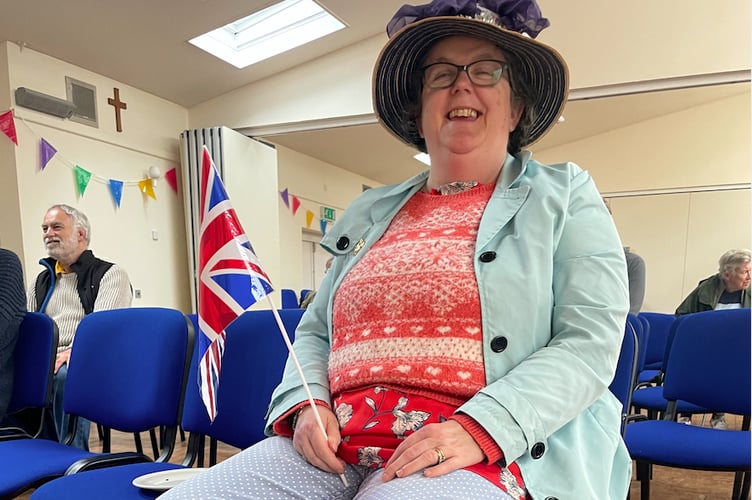 One of the members of the public who watched the ceremony in the Boniface Centre, complete with a flag and Union flag decorated boots.  AQ 7608