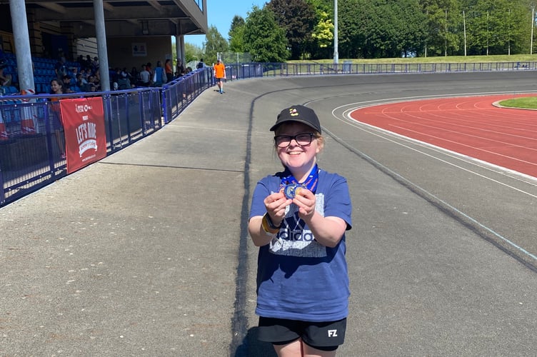 Dee Weiner with the gold, silver and bronze medals she won at the National Dwarf Games.