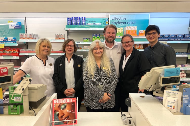 Wendy, centre, is retiring from working for Boots the chemist after 45 years, pictured with colleagues at the Crediton branch.  AQ 9675