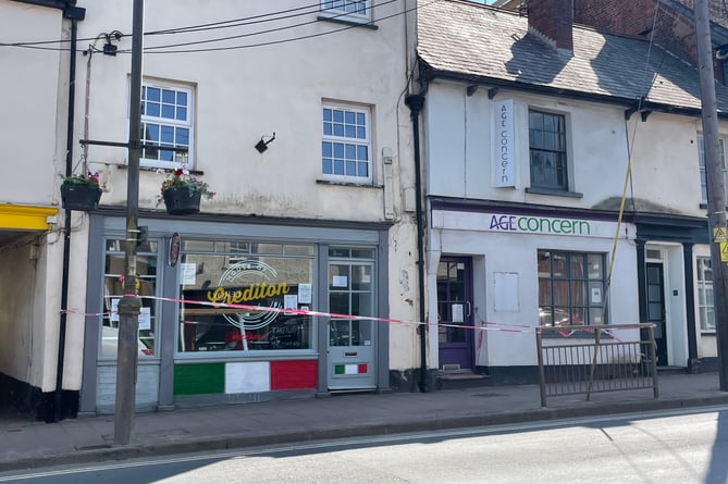 The taped off area of pavement in Crediton High Street.  AQ 0369