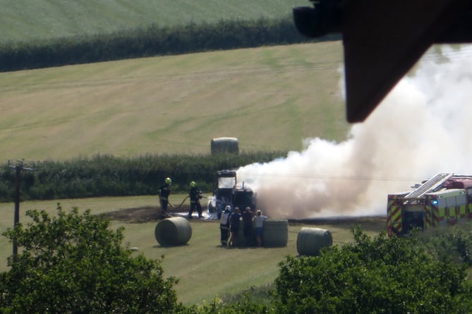 Firefighters tackling the telehandler fire.  SR 3191        