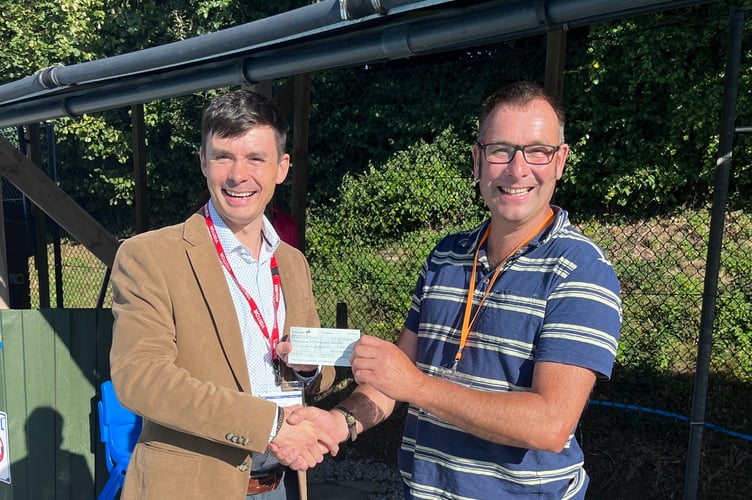 The presentation being made by Crediton Freemason Lee Fallows, left, to Rob Bishop, Bow Swimming Pool Committee Chair person.