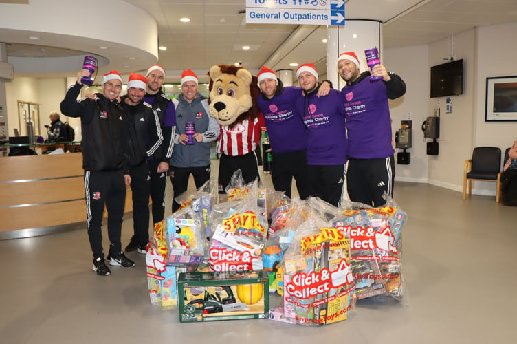 Exeter City FC players delivering presents to children in the Bramble Ward at the Royal Devon and Exeter Hospital.
