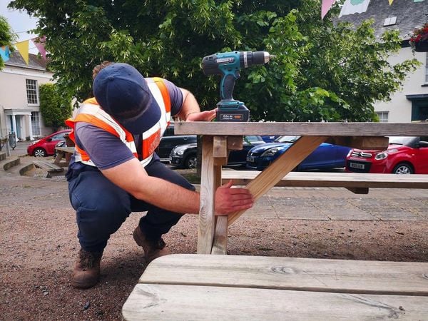 One of The Turning Tides Project team carrying out maintenance on one of the benches in the Town Square.
