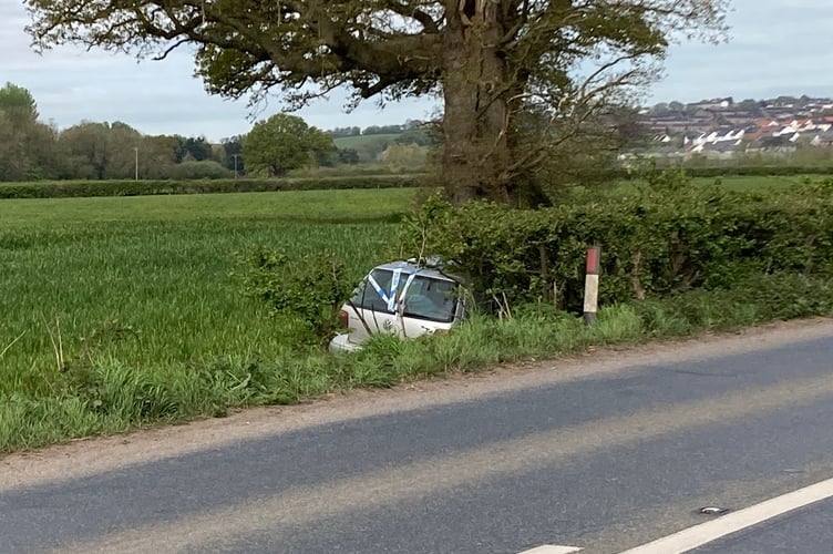 Silver VW hatchback in field A377 near Crediton