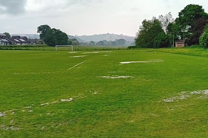 The water-logged pitch following the thunderstorm at about 3pm on Saturday.
