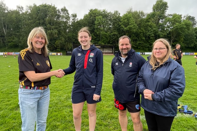 Liz Gimmler, Girls Manager at Crediton RFC, left, thanks Red Roses Ace Emma Sing for attending the Tag Rugby session, with Scott Baker and Sam Buller, club coaches.  AQ 3237
