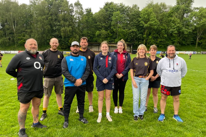 Red Roses Ace Emma Sing, centre, with Crediton Rugby Club team managers, assistants and volunteers, during her visit to Crediton Rugby Club.  AQ 3159
