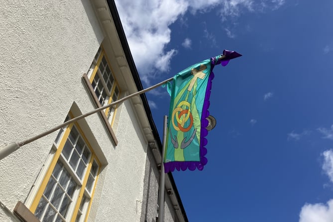 Crediton Congregational Church's new flag above newspaper office
