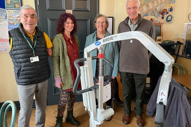 The hoist now available at The Station Tea Rooms in Crediton, with, from left, County Councillor Frank Letch, Jane Williams, Director of The Turning Tides Project, County Councillors Mrs Margaret Squires and Gary Adams, President, The Rotary Club of Crediton Boniface.  AQ 9909
