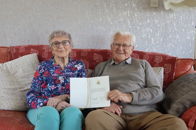 Julie and Colin Rowe with their letter from His Majesty The King