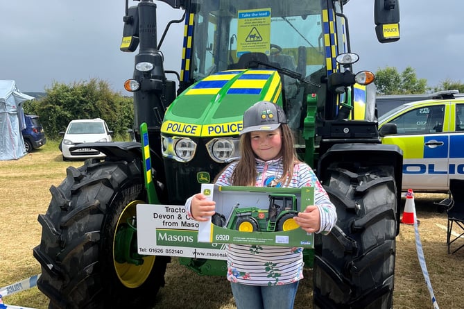 Competition winner, Eloise Bettison, with police tractor 'Inspector Moors’.