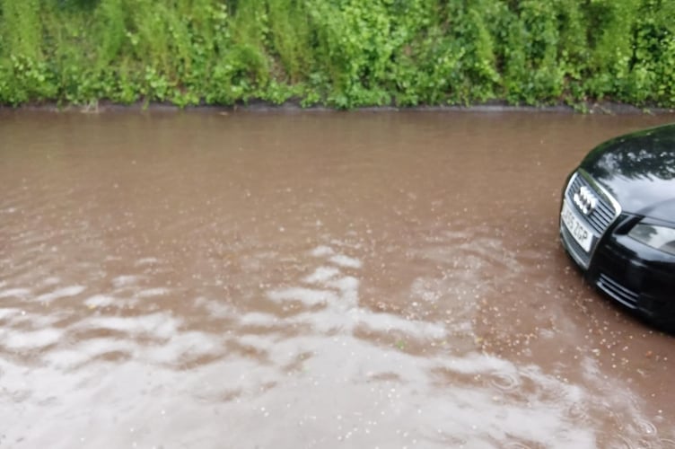 A car sitting in the floodwater.