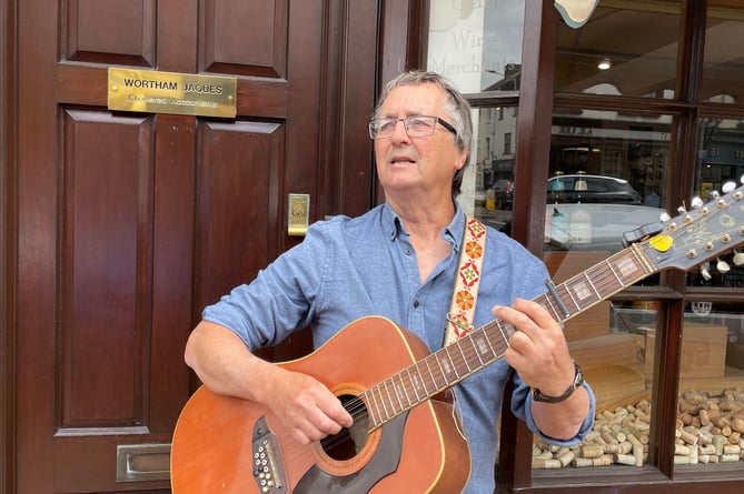 Julian Wild busking outside Wortham Jaques chartered accountants.  AQ 5580