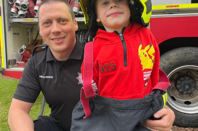 Dressing up as a firefighter was fun at the fete.  AQ 5551
