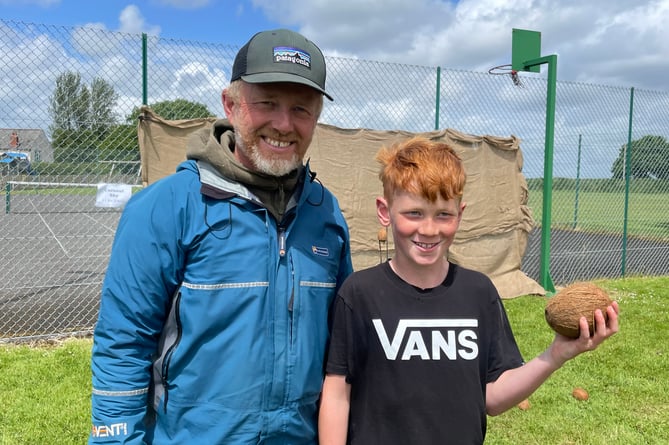 Elton Hutchinson ran the coconut shy and he is pictured with his son Raffie after he won a coconut.  AQ 5185
