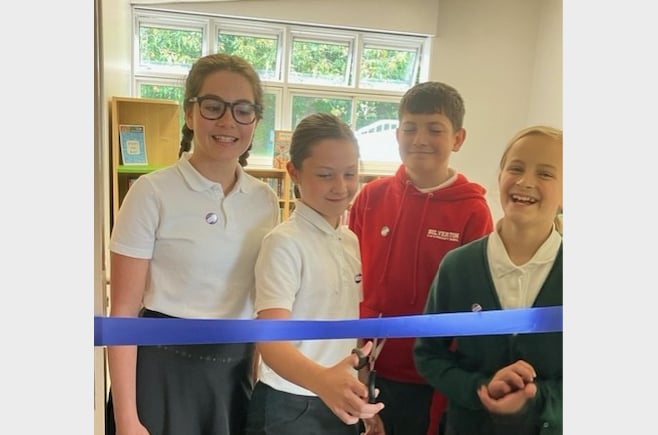 The school librarians cut the ribbon and declared the library open. 
