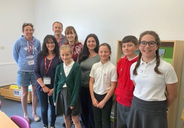 The school librarians and PTA members and staff in the library. 
