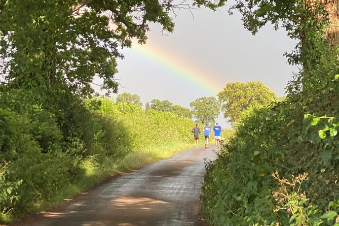 A rainbow as the group run into the distance.
