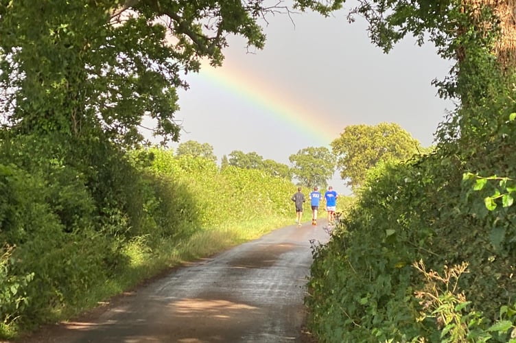 A rainbow as the group run into the distance.
