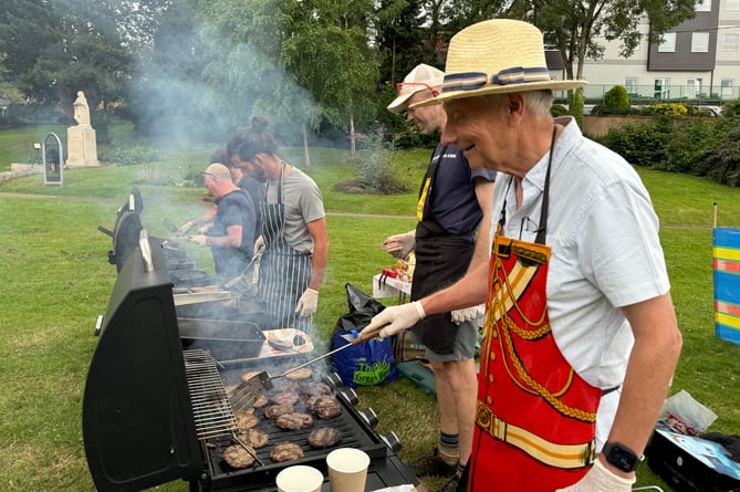 Cooking lots of burgers.  AQ 7506
