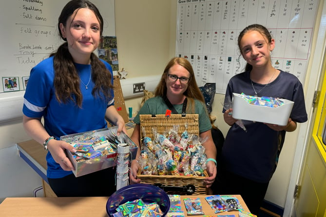 Sweets and jewellery were for sale on the stall run by Olivia, Kealley and Isabella.  AQ 7915