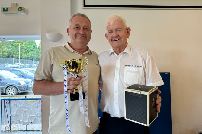 Dave Blanchford received a tankard from Crediton United FC from Dave Pike, left.  AQ 7941
