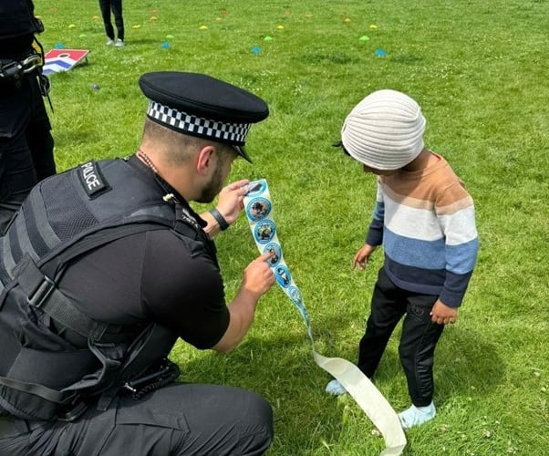 Sergeant James Wellard giving out stickers at the Nigerian community day.
