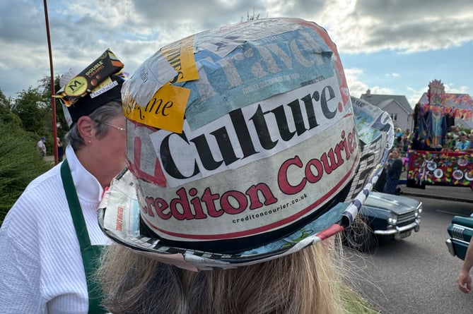 One of the Cheriton Fitzpaine Community Shop volunteers used a Crediton Courier to decorate her hat.  AQ 8624
