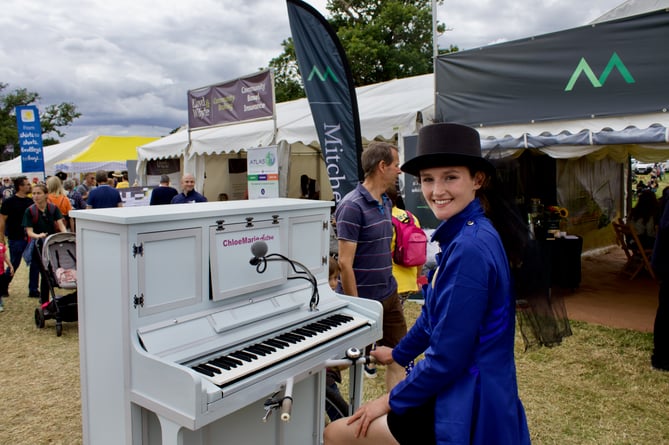 Chloe Marie Aston with her piano bicycle