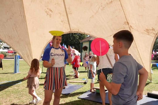 Learn to spin plates at the circus skills workshop.