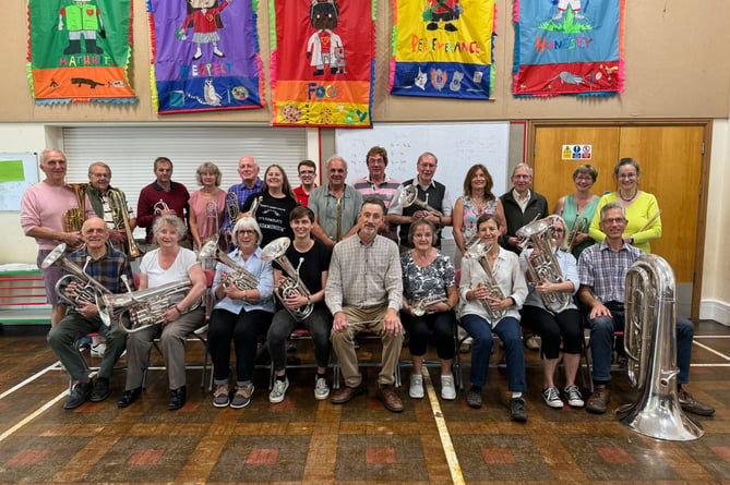 Iorwerth Pugh, centre, front row, Crediton Town Band’s Musical Director with some of the Band members at a rehearsal evening. AQ 9663
