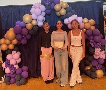 Okehampton College students Alya, Freya and Mae with their results envelopes