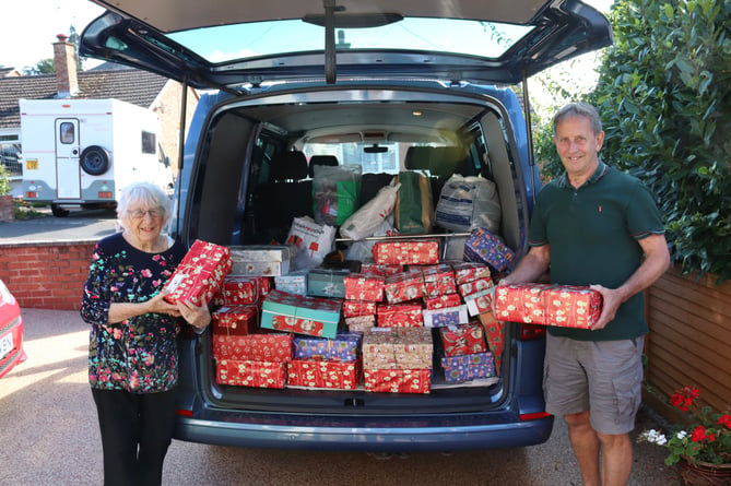 Margaret Tucker and Biffo Holland with shoeboxes loaded into van