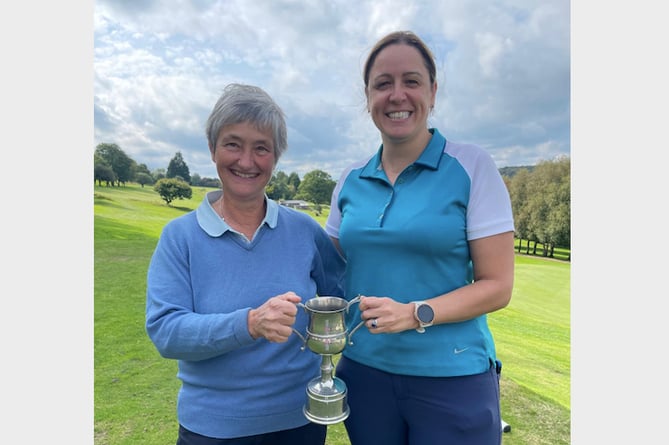 Sue Williams (Lady Captain), left, presenting the trophy to Okehampton Club Champion Abby Turner.
