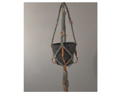 A macrame plant pot holder.
