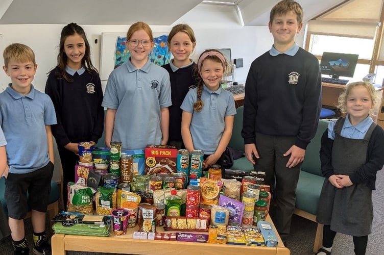 Members of the Sandford School council with some of the food that will be donated to Crediton Food Bank.
