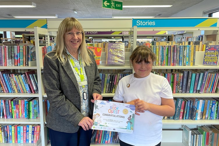 Chloe receiving certificate from Sue Lee at Crediton Library