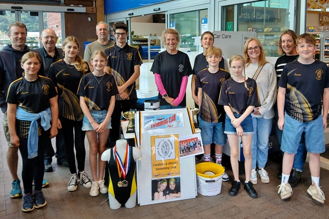 Members of Crediton and District Swimming Club who took part in bag packing at Crediton Tesco store. 
