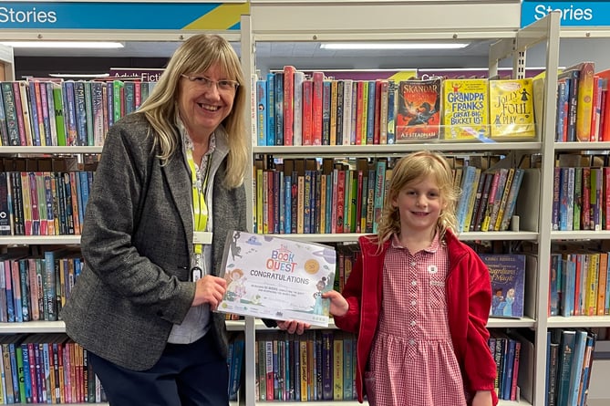 Hannah receiving certificate from Sue Lee at Crediton Library